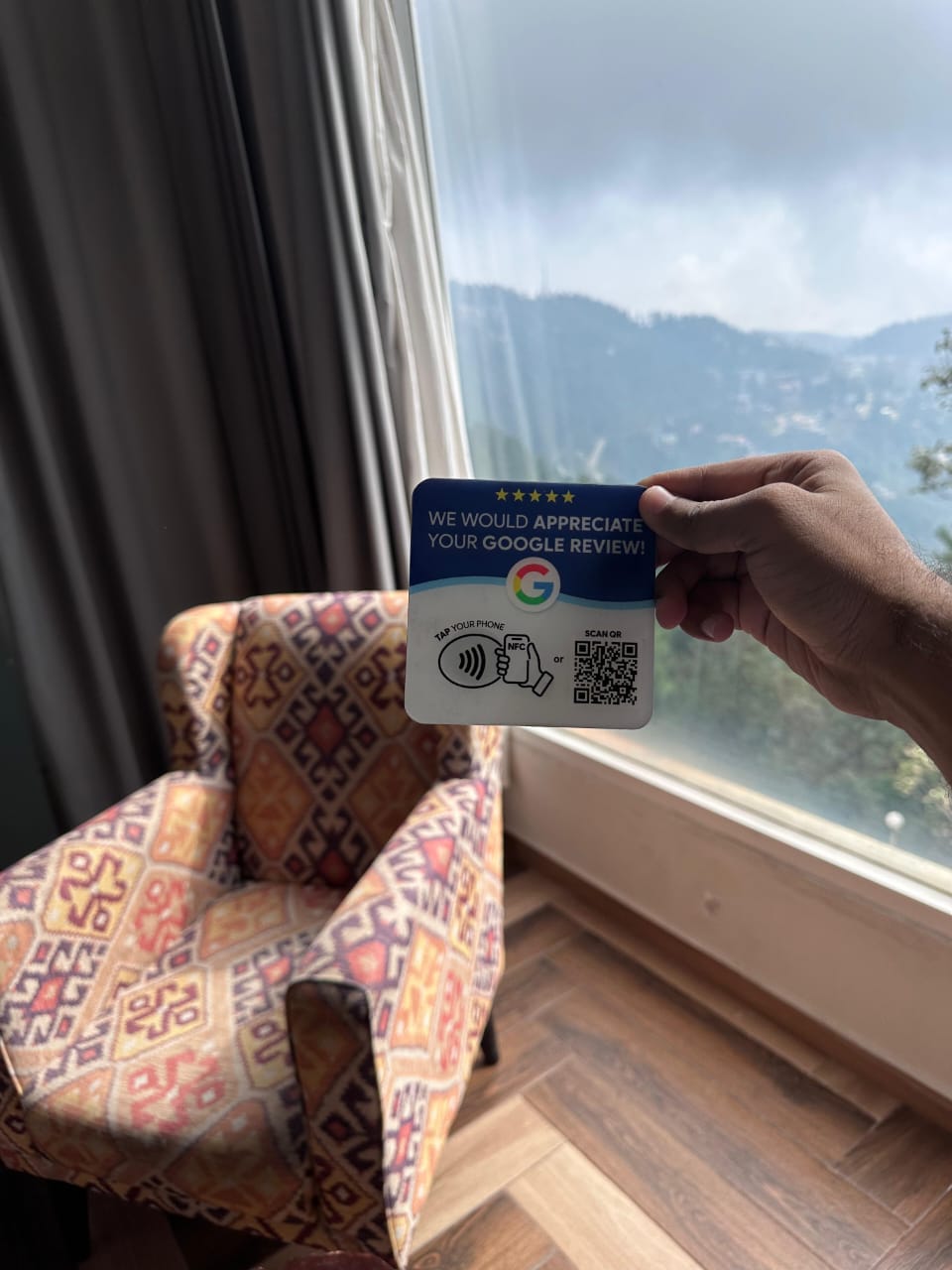 A 4 by 4 inch NFC and QR Google review card held up in a real setting